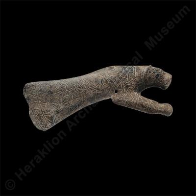 Stone sceptre head in the shape of an axe and panther