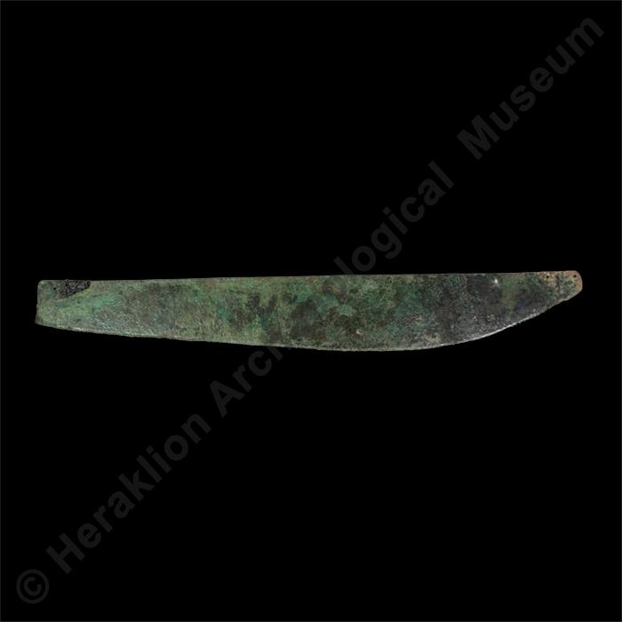 Large bronze saw with carbonised remains of wooden handle